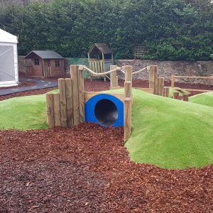 Playground in-ground mound tunnel with blue tunnel entrance