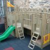 Mars Montessori raised timber bridge with slide ladders and play panel