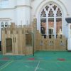 Old Vicarage compact timber adventure play fort with scramble net firepole and coloured wet-pour surfacing