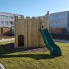 Playground Castle with slide and crenelated timber walls