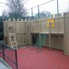 St Christopher's linked timber play structure with climbing wall ladder raised walkway and scramble net