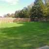 Grass playground surface around outdoor play area