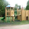Woodchester School double adventure play with linked castle climbing den slides and net bridge