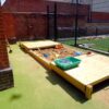 Bespoke sandpit with timber roller cover