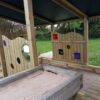Bespoke sandpit with sensory panels and covered play space