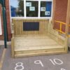Compact timber chalkboard stage fitted beside a school building and existing railings