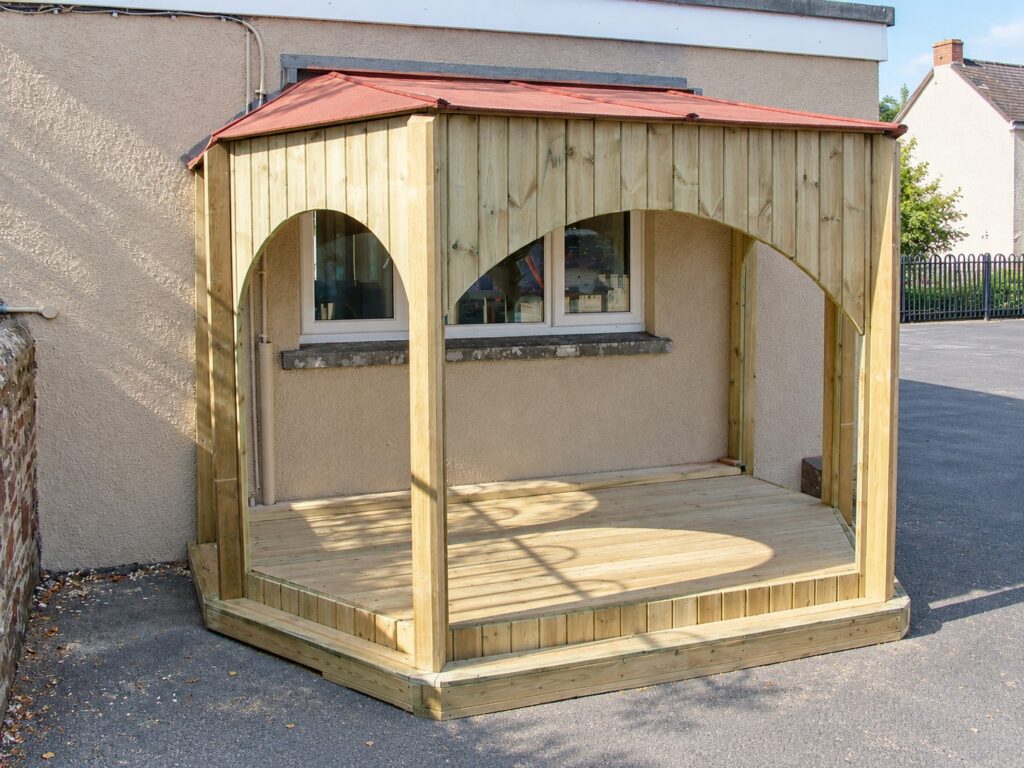 Covered timber performance stage with an arched frontage and open sides