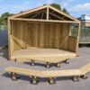 Covered timber playground stage with two separate audience benches