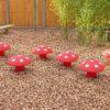 Six mushroom seats grouped on woodchip at Belleville School