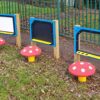 Mushroom seats beside drawing and writing panels at Halley Nursery