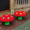 Two mushroom seats with green stems and coloured spots at Stroud Valley