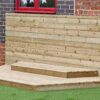 Low timber performance stage with a horizontal-board backdrop beside a school building