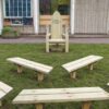 Timber storytelling chair with Once upon a time lettering and separate benches on grass