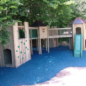Deviock multi adventure play area with timber towers, slide and blue safety surfacing
