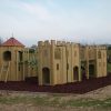 Gypsy Wood gatehouse towers with slide and rubber mulch surfacing
