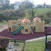 Wider view of Gypsy Wood adventure play area with slide and timber towers