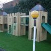 Hampton adventure play towers with open slide and climbing net