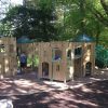 Merlewood timber play structure with slide under trees