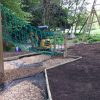 Merlewood climbing wall with activity trail in the wooded play area