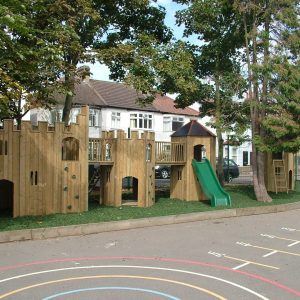 Oakdale timber castle play area with slide and linked towers