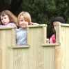 Children playing in a garden play turret