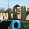 Skelton adventure play towers with slide and climbing features