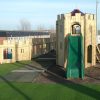 Skelton slide tower with timber climbing and access features