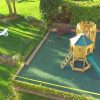 High angle view of St Brelades double adventure play area with turret slide and green safety surfacing