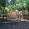 The Downs woodland adventure play structure with timber towers, bridges and bark surfacing