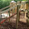 Rope tunnel route beneath the raised timber play structure at The Downs