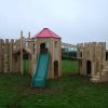 Downes Combo timber multi adventure play structure with slide, tower and gatehouse
