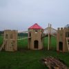 Bridge and gatehouse view of the Downes Combo timber play structure