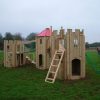 Rear tower view of the Downes Combo play structure with ladder and scramble net