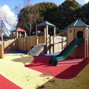 Mont A L'Abbe bespoke adventure play with linked timber towers slide and colourful safety surfacing