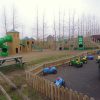 West Lodge bespoke adventure play mound with tube slide net bridge and timber towers