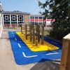 Four Acres Academy timber play frame with roadway markings and wet-pour surfacing