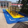 Four Acres Academy roadway play markings with blue and yellow wet-pour surfacing