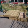 Four Acres Academy timber seating platform in school playground