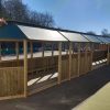 Long bespoke outdoor classroom with timber seating and covered learning space