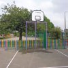 Metal multi goals with basketball hoop on a marked playground court