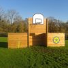 Installed wooden multi-use goals in a grass play area
