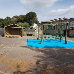 Croft school play space with timber play frame stage wet-pour surfacing and playground markings