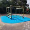Croft timber play frame with blue wet-pour surfacing and playground markings