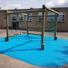 Croft timber play frame with blue wet-pour safety surfacing
