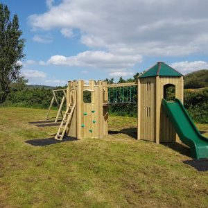 Walford Village Hall playground with tower turret slide bridge and double swings
