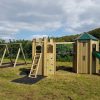 Walford Village Hall tower turret slide and double swing frame in open play area