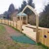 Lyppard Grange memorial garden entrance arch with rainbow fencing and timber boardwalk