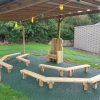 Lyppard Grange sheltered storytelling area with timber benches