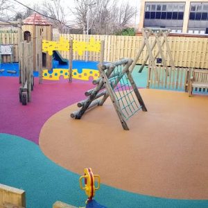 Commercial Flats Bristol courtyard playground with tower swings activity play panels and coloured wet-pour surfacing