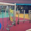 Commercial Flats Bristol swing frame play panels and activity equipment in a courtyard play area